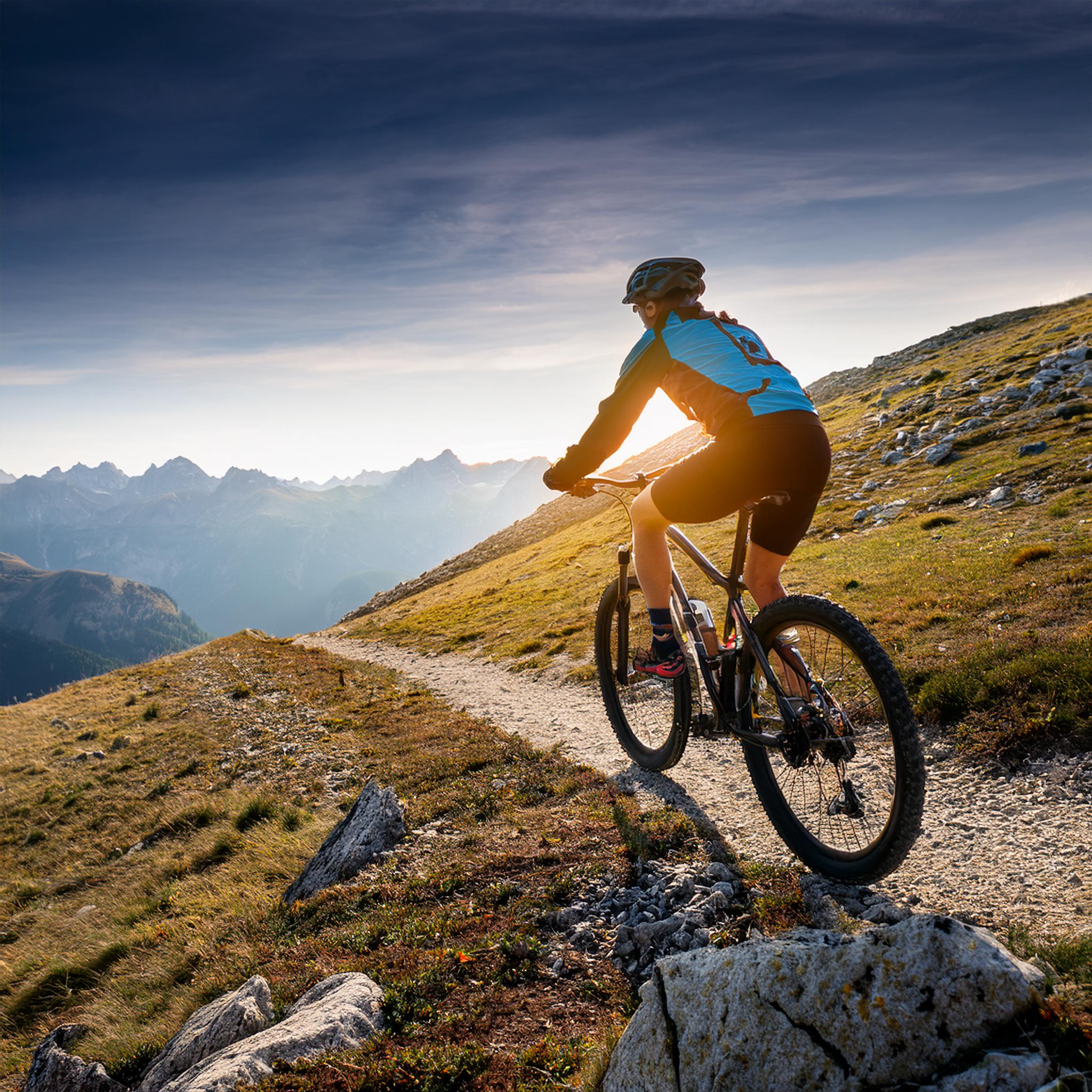woman-riding-mountain-bike-trail
